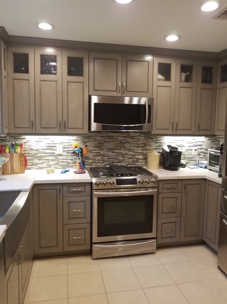 Photo of a small contemporary u-shaped enclosed kitchen in Houston with a belfast sink, raised-panel cabinets, grey cabinets, engineered stone countertops, grey splashback, metal splashback, stainless steel appliances, porcelain flooring, no island and beige floors.