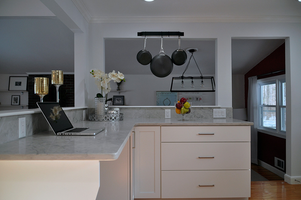 Design ideas for a medium sized classic l-shaped kitchen in Boston with a belfast sink, shaker cabinets, white cabinets, engineered stone countertops, white splashback, ceramic splashback, stainless steel appliances, light hardwood flooring, no island and yellow floors.