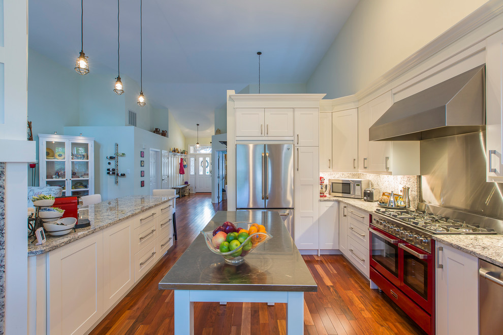 Klassische Küche mit Schrankfronten im Shaker-Stil, weißen Schränken, Küchenrückwand in Metallic, braunem Holzboden und zwei Kücheninseln in Raleigh