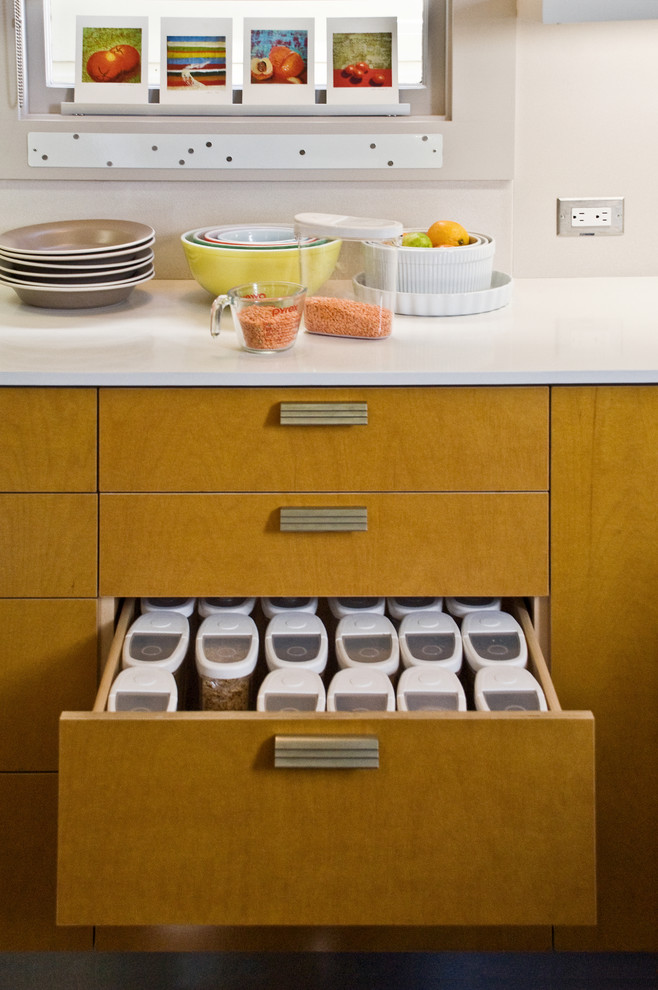 Enclosed kitchen - mid-sized contemporary l-shaped laminate floor enclosed kitchen idea in San Francisco with flat-panel cabinets, medium tone wood cabinets, an undermount sink, quartz countertops, white backsplash, stainless steel appliances and no island