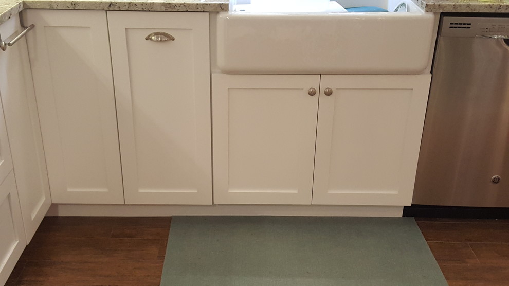 This is an example of a medium sized classic l-shaped kitchen in Miami with a belfast sink, shaker cabinets, white cabinets, granite worktops, multi-coloured splashback, mosaic tiled splashback, stainless steel appliances and ceramic flooring.