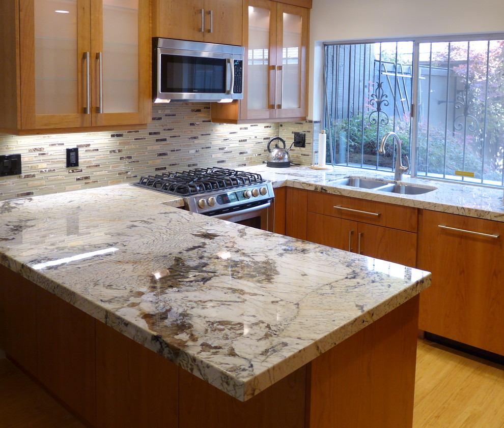 Trendy u-shaped kitchen photo in Salt Lake City with an undermount sink, granite countertops and stainless steel appliances