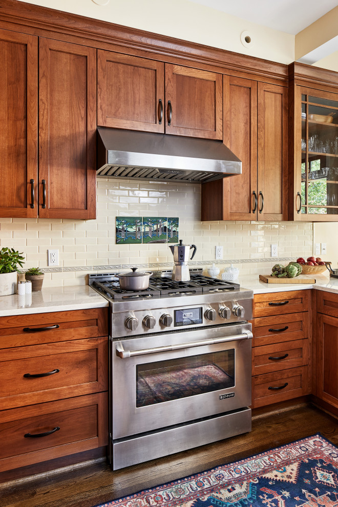 Design ideas for a medium sized classic kitchen in DC Metro with medium wood cabinets, beige splashback, metro tiled splashback, stainless steel appliances, medium hardwood flooring and white worktops.