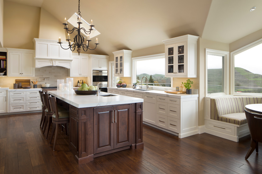 Large elegant l-shaped dark wood floor eat-in kitchen photo in San Francisco with an undermount sink, recessed-panel cabinets, white cabinets, an island, marble countertops, white backsplash and marble backsplash