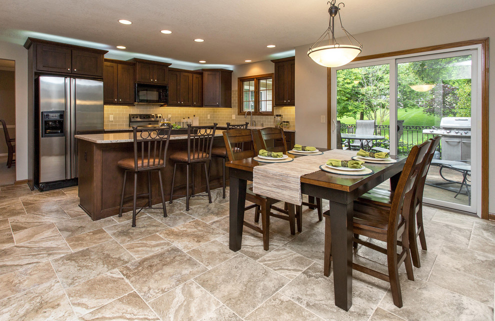 Mid-sized elegant l-shaped ceramic tile and beige floor open concept kitchen photo in Other with an undermount sink, recessed-panel cabinets, medium tone wood cabinets, quartz countertops, white backsplash, glass tile backsplash, stainless steel appliances, an island and beige countertops