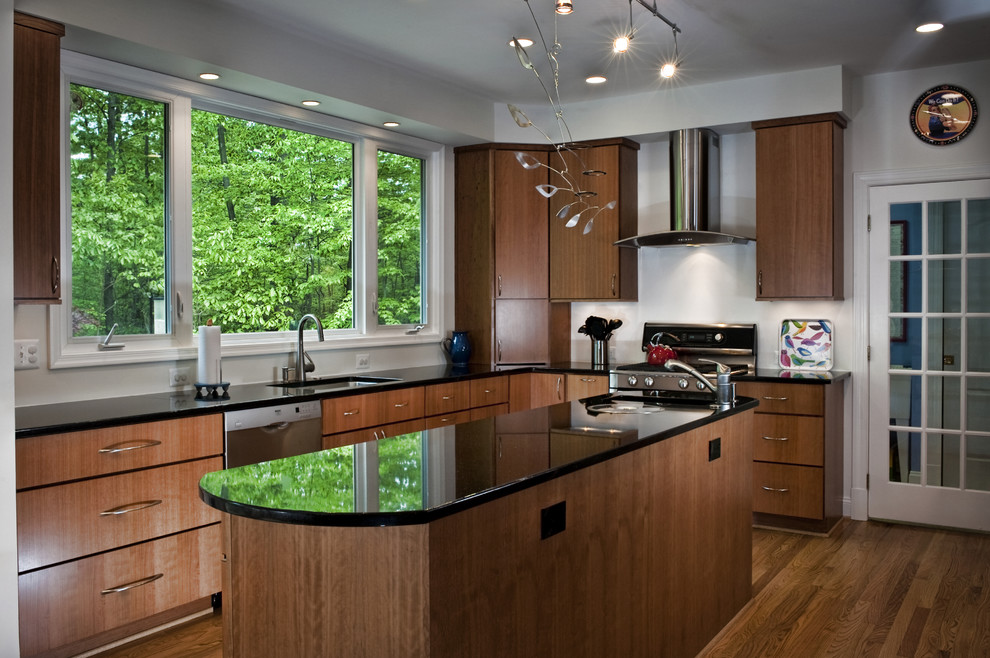 Photo of a medium sized contemporary galley kitchen/diner in DC Metro with flat-panel cabinets, medium wood cabinets, stainless steel appliances, medium hardwood flooring and an island.