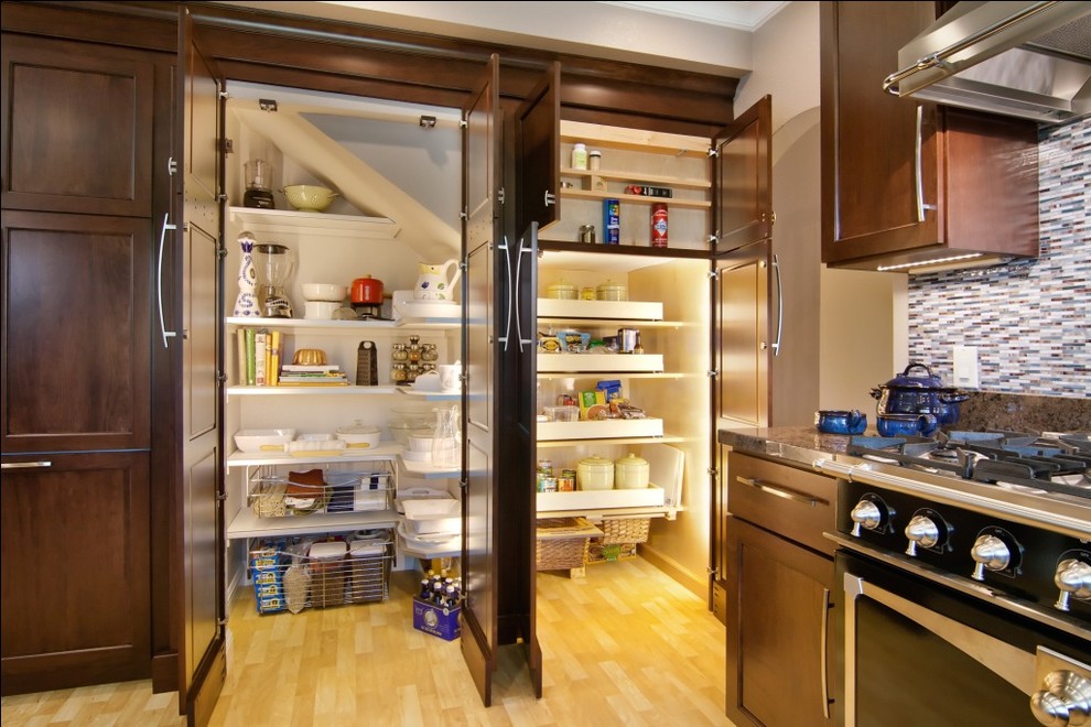 Elegant kitchen pantry photo in San Francisco with matchstick tile backsplash, black appliances, multicolored backsplash, dark wood cabinets and recessed-panel cabinets