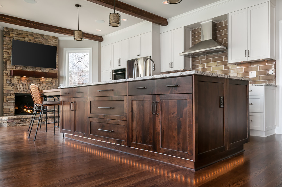 Kitchen - traditional dark wood floor and brown floor kitchen idea in Atlanta with shaker cabinets, white cabinets, brown backsplash, subway tile backsplash, stainless steel appliances and an island