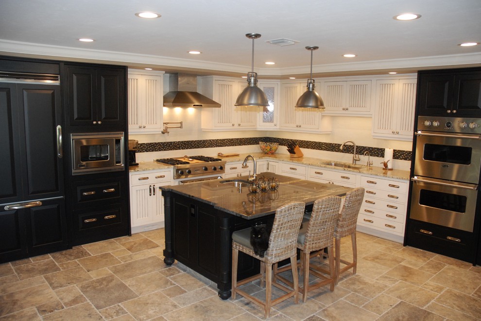 Inspiration for a large transitional l-shaped travertine floor open concept kitchen remodel in Tampa with an undermount sink, beaded inset cabinets, distressed cabinets, granite countertops, multicolored backsplash, porcelain backsplash, stainless steel appliances and an island