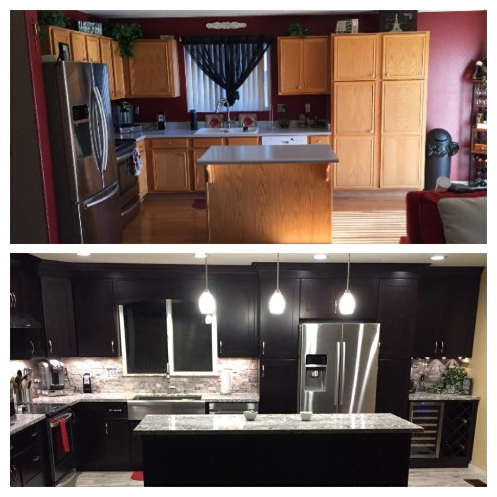 Foto di una cucina minimalista di medie dimensioni con lavello sottopiano, ante nere, top in granito, paraspruzzi grigio, paraspruzzi in travertino, elettrodomestici in acciaio inossidabile e pavimento grigio