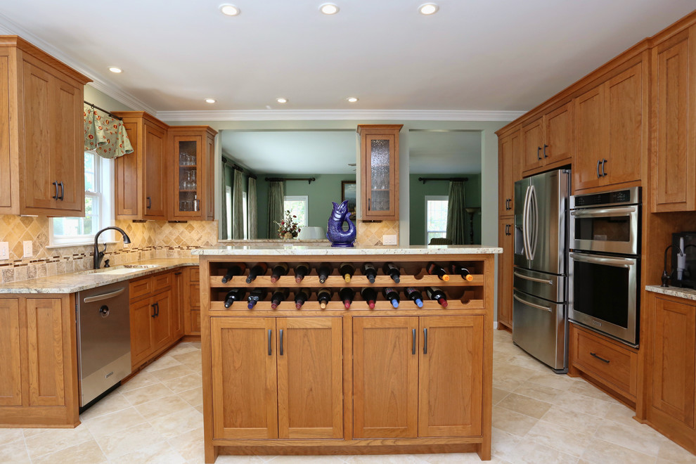 Example of a mid-sized classic u-shaped travertine floor and beige floor open concept kitchen design in Raleigh with an undermount sink, shaker cabinets, medium tone wood cabinets, granite countertops, beige backsplash, stone tile backsplash, stainless steel appliances and an island