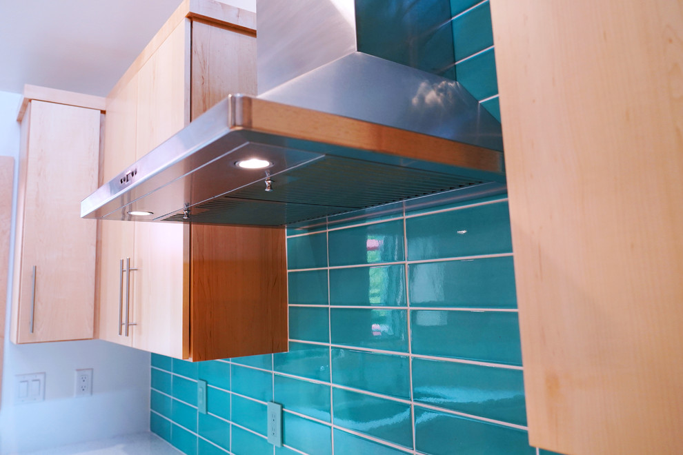 Photo of a medium sized retro kitchen/diner in Other with a built-in sink, flat-panel cabinets, medium wood cabinets, engineered stone countertops, blue splashback, stainless steel appliances, light hardwood flooring, a breakfast bar and white worktops.
