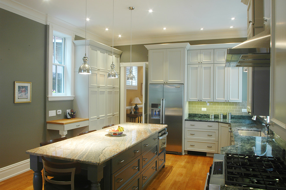 This is an example of a medium sized traditional l-shaped kitchen in Richmond with a single-bowl sink, recessed-panel cabinets, white cabinets, marble worktops, metro tiled splashback, stainless steel appliances, light hardwood flooring, an island, green splashback and brown floors.