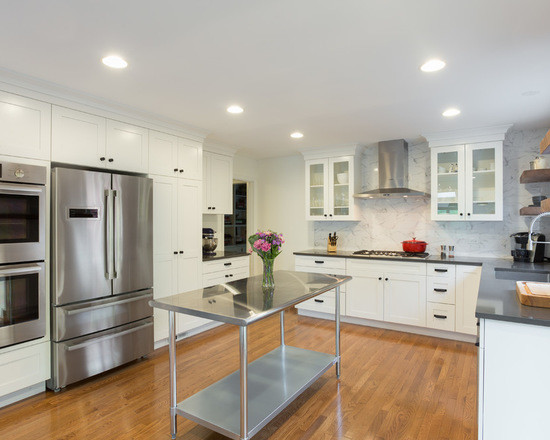 Inspiration for a mid-sized contemporary galley medium tone wood floor eat-in kitchen remodel in Chicago with an undermount sink, shaker cabinets, white cabinets, granite countertops, white backsplash, marble backsplash, stainless steel appliances and an island
