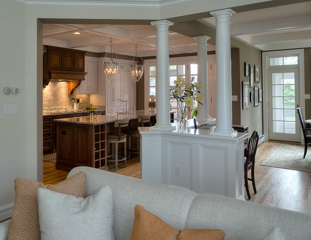 This is an example of a classic kitchen in DC Metro with raised-panel cabinets and an island.