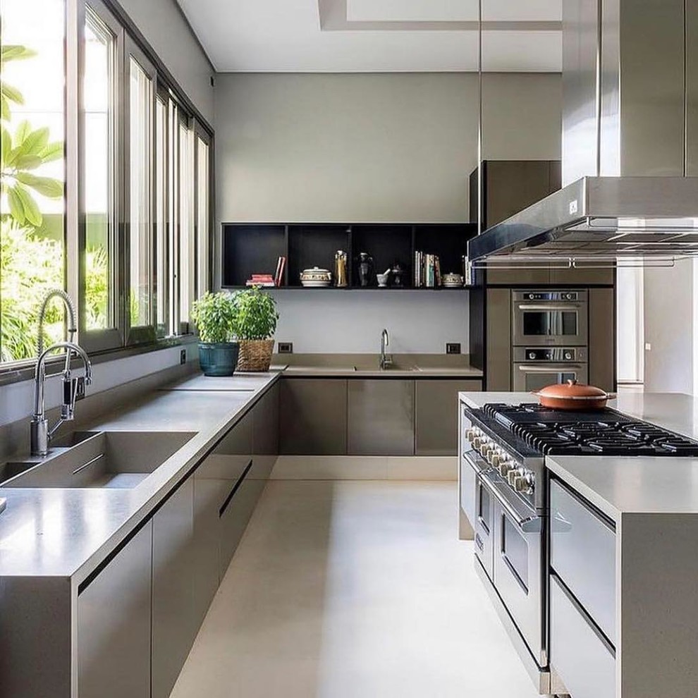 Inspiration for a modern u-shaped open plan kitchen in San Francisco with an integrated sink, flat-panel cabinets, grey cabinets, granite worktops, stainless steel appliances, porcelain flooring, an island, white floors and grey worktops.