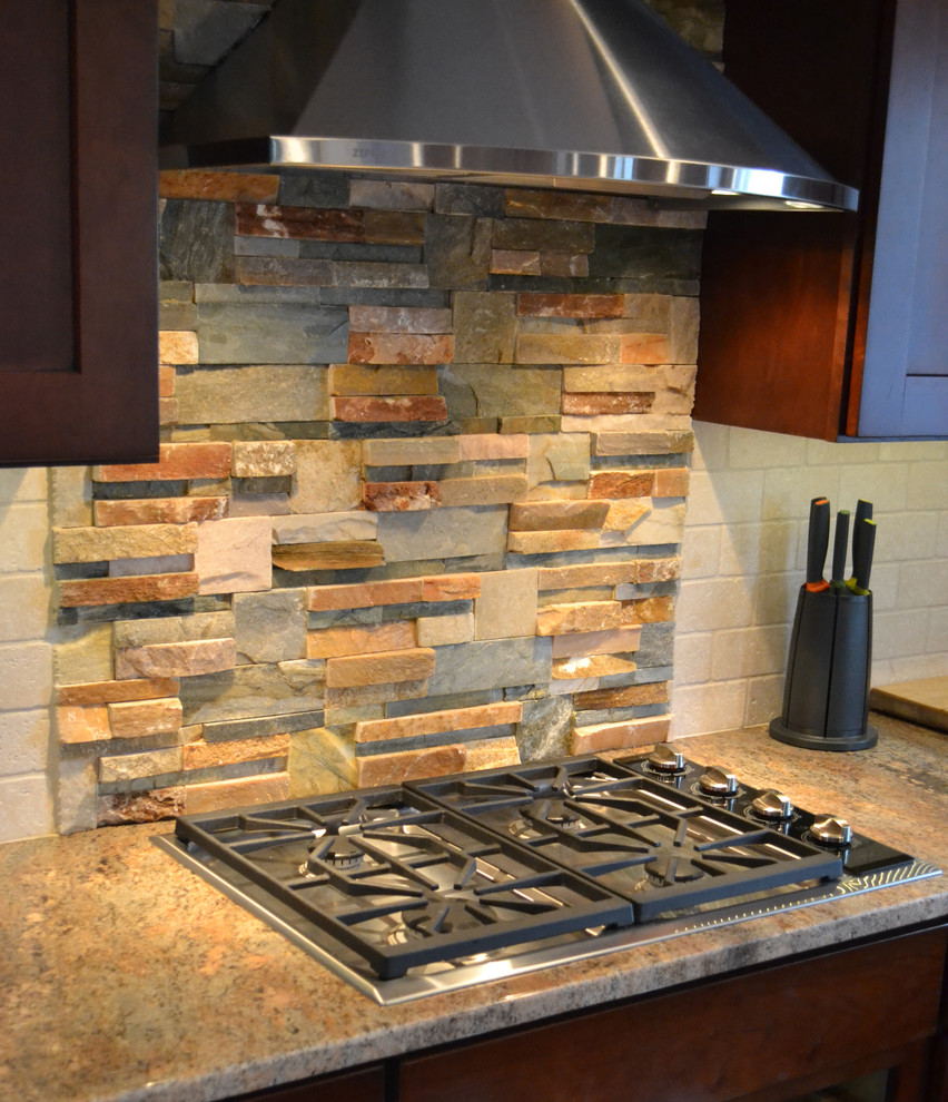 Example of a classic l-shaped eat-in kitchen design in Other with an undermount sink, shaker cabinets, dark wood cabinets, granite countertops, multicolored backsplash, stone tile backsplash and stainless steel appliances