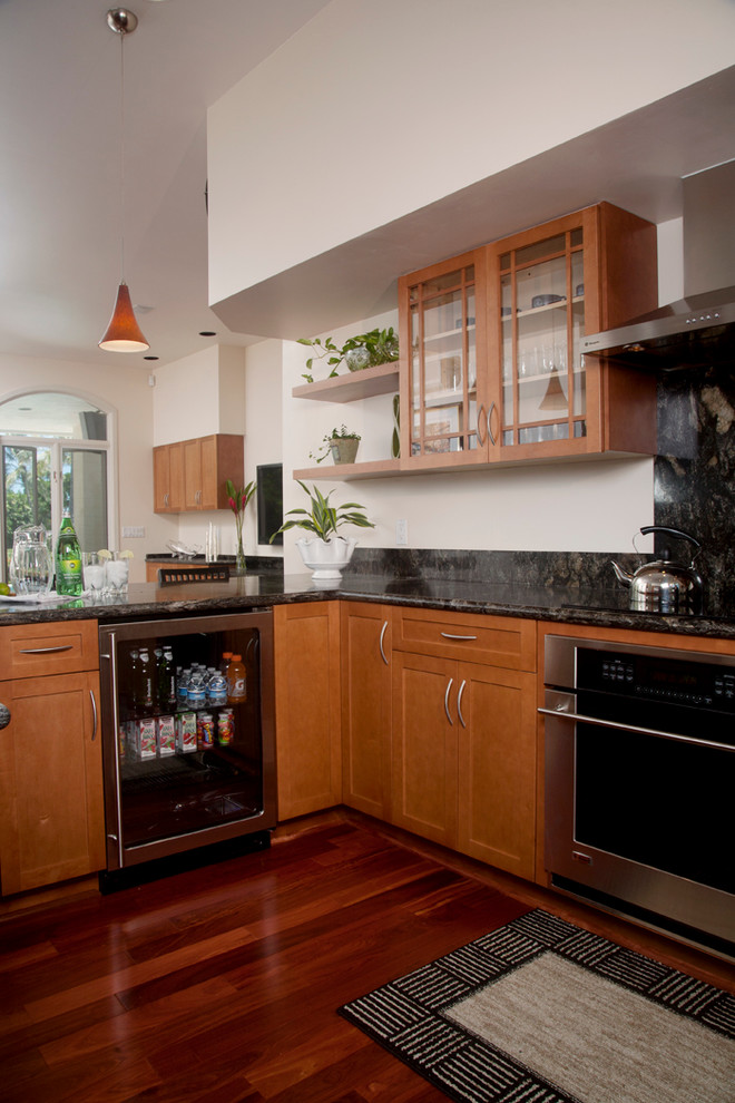 This is an example of a contemporary kitchen in Hawaii with shaker cabinets, medium wood cabinets, granite worktops, multi-coloured splashback and stainless steel appliances.