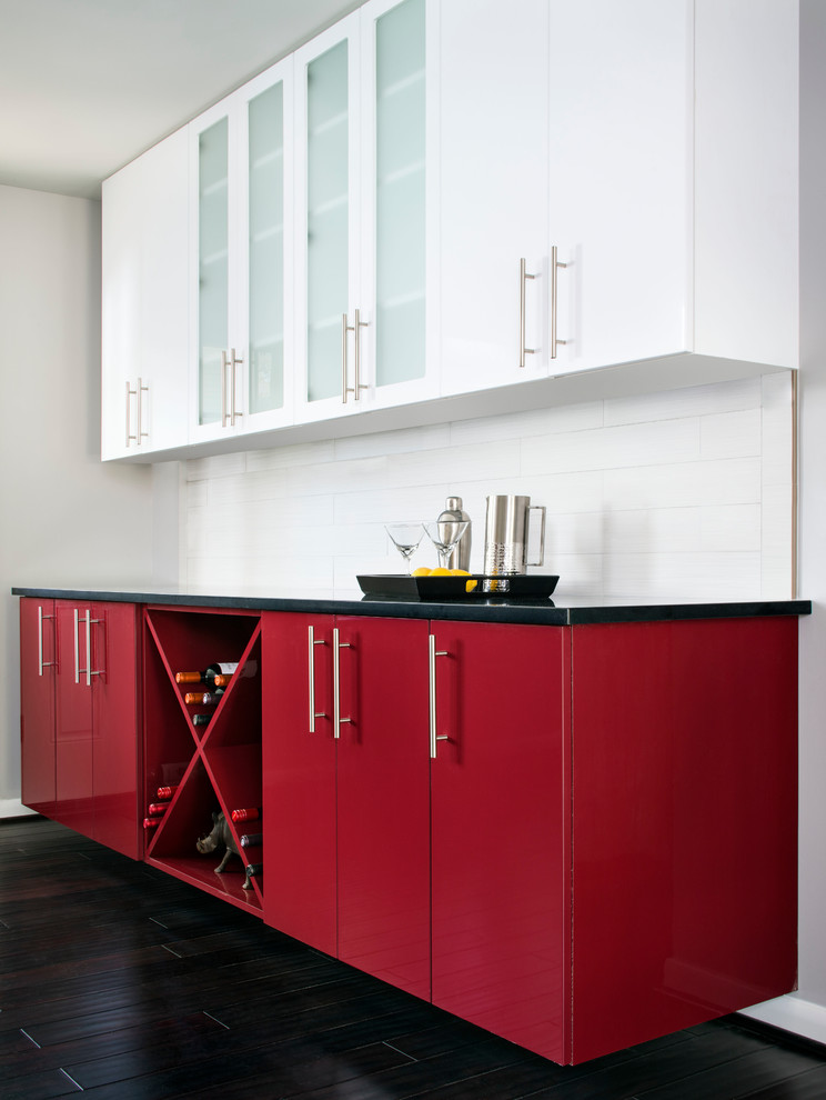 Kitchen - contemporary dark wood floor kitchen idea in DC Metro with flat-panel cabinets, red cabinets and white backsplash
