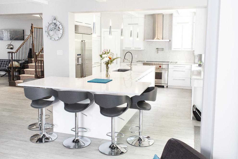 Example of a mid-sized trendy u-shaped ceramic tile and gray floor kitchen design in Ottawa with an undermount sink, flat-panel cabinets, white cabinets, quartz countertops, white backsplash, stainless steel appliances, an island and white countertops
