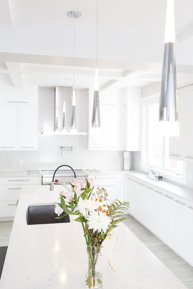 Kitchen - mid-sized contemporary u-shaped ceramic tile and gray floor kitchen idea in Ottawa with an undermount sink, flat-panel cabinets, white cabinets, quartz countertops, white backsplash, stainless steel appliances, an island and white countertops