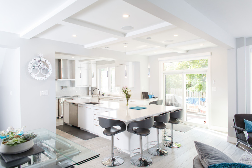 Mid-sized trendy u-shaped ceramic tile and gray floor kitchen photo in Ottawa with an undermount sink, flat-panel cabinets, white cabinets, quartz countertops, white backsplash, stainless steel appliances, an island and white countertops