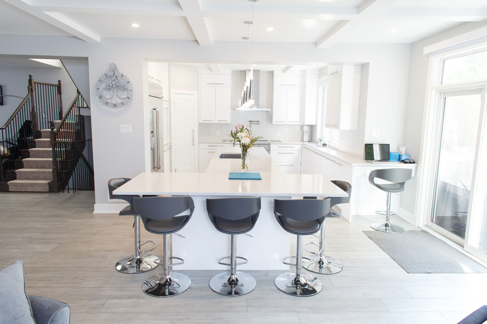 Kitchen - mid-sized contemporary u-shaped ceramic tile and gray floor kitchen idea in Ottawa with an undermount sink, flat-panel cabinets, white cabinets, quartz countertops, white backsplash, stainless steel appliances, an island and white countertops
