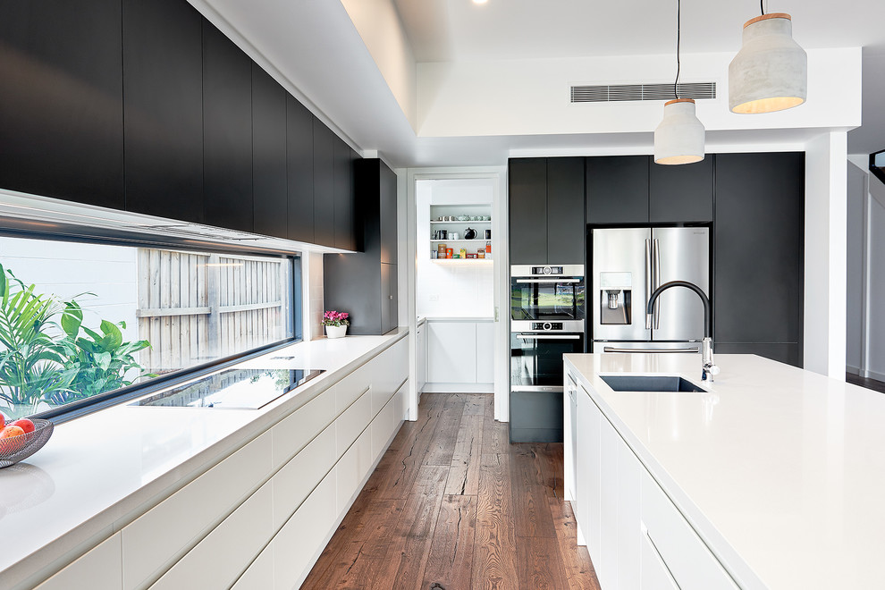 Open concept kitchen - large contemporary l-shaped dark wood floor open concept kitchen idea in Melbourne with a single-bowl sink, flat-panel cabinets, black cabinets, quartz countertops, window backsplash, stainless steel appliances and an island