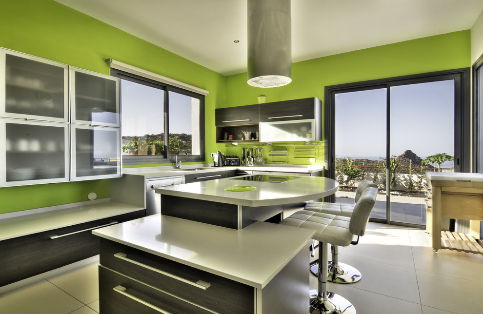 Mittelgroße Mid-Century Küche in L-Form mit Vorratsschrank, Glasfronten, Edelstahlfronten, Mineralwerkstoff-Arbeitsplatte, Küchengeräten aus Edelstahl und Kücheninsel in Vancouver