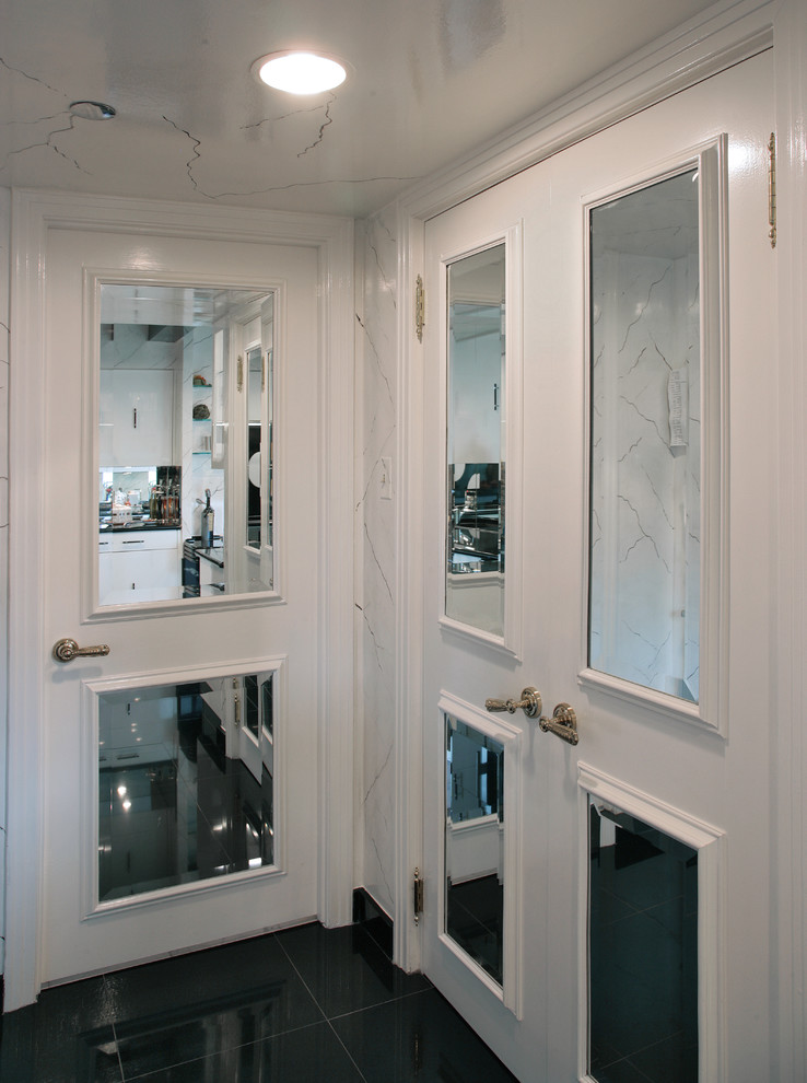 Imagen de cocina actual grande con puertas de armario blancas, encimera de granito, salpicadero con efecto espejo y electrodomésticos de acero inoxidable