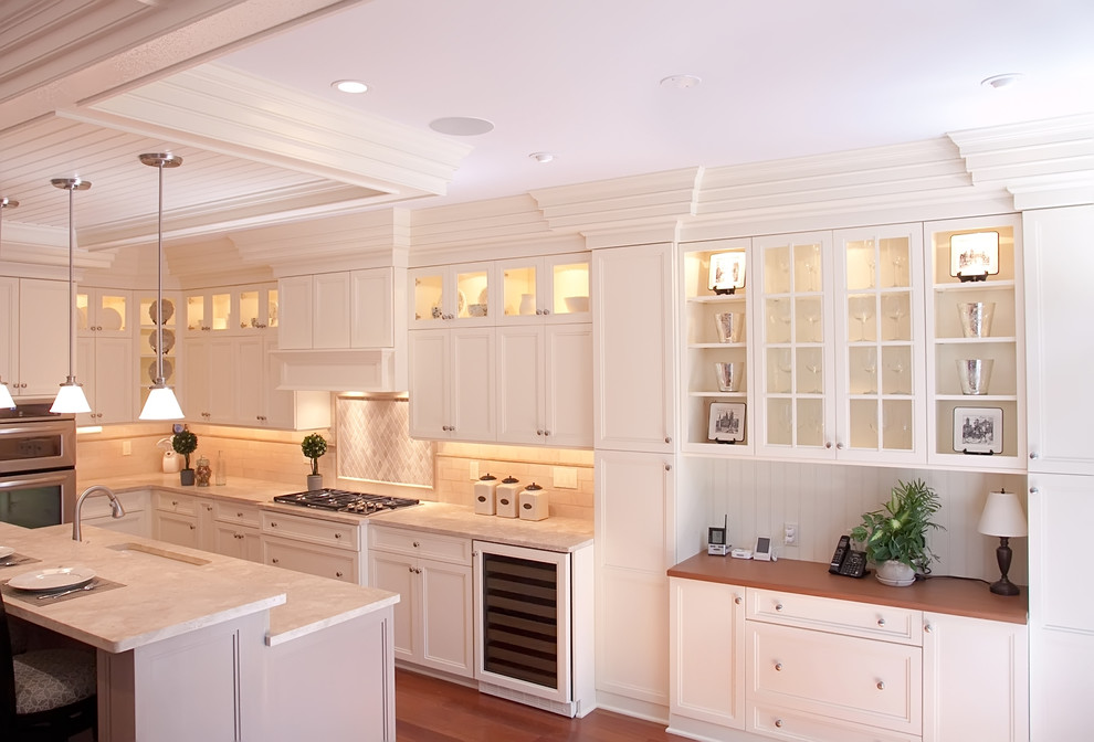 Inspiration for a large timeless l-shaped medium tone wood floor eat-in kitchen remodel in Philadelphia with white cabinets, subway tile backsplash, stainless steel appliances, white backsplash, granite countertops, recessed-panel cabinets, an undermount sink and an island