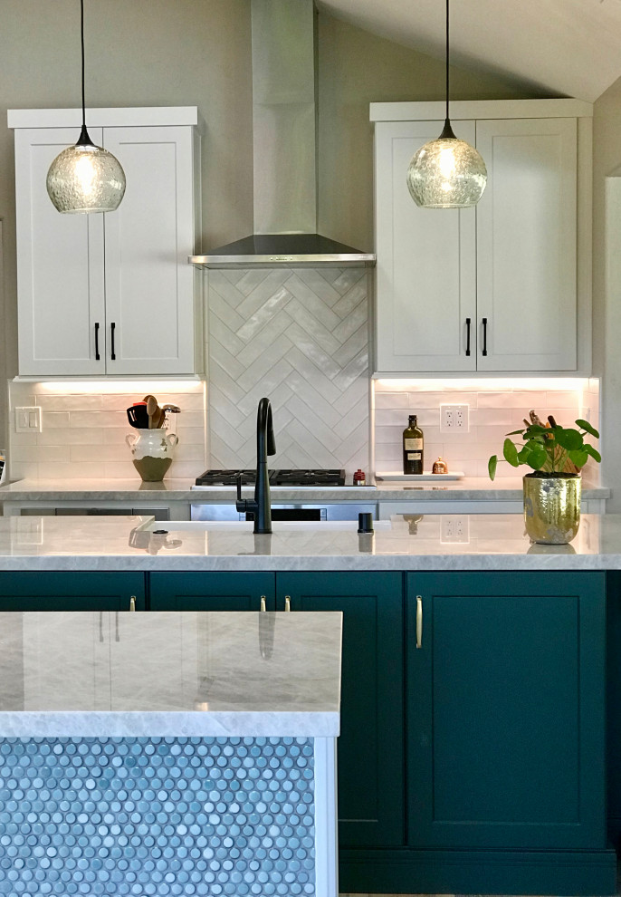 Inspiration for a medium sized traditional kitchen in San Diego with a belfast sink, shaker cabinets, white cabinets, quartz worktops, white splashback, metro tiled splashback, stainless steel appliances, multiple islands, multi-coloured floors and white worktops.