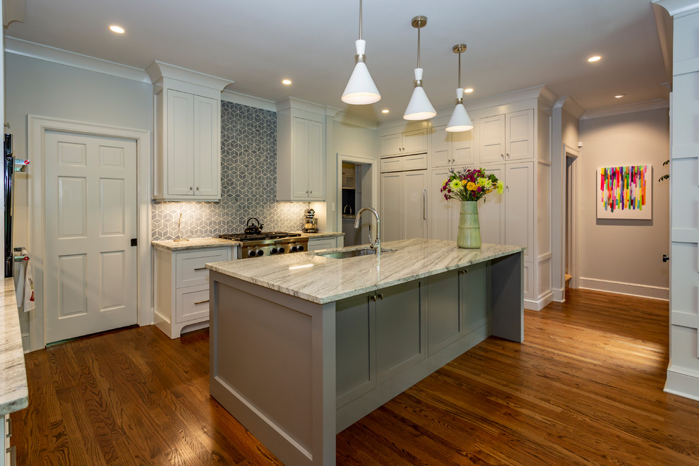 Example of a large transitional u-shaped medium tone wood floor and brown floor eat-in kitchen design in Charlotte with an undermount sink, recessed-panel cabinets, gray cabinets, marble countertops, blue backsplash, porcelain backsplash, stainless steel appliances, an island and multicolored countertops