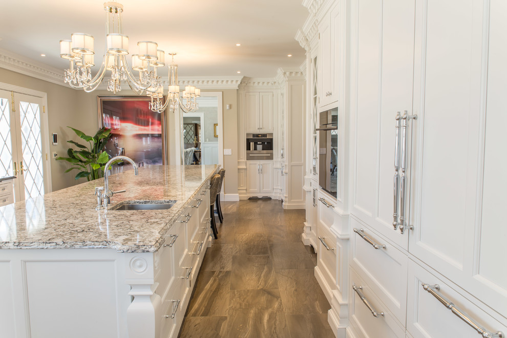Inspiration for a large timeless galley porcelain tile eat-in kitchen remodel in New York with an undermount sink, beaded inset cabinets, white cabinets, quartzite countertops, white backsplash, stone tile backsplash, paneled appliances and an island