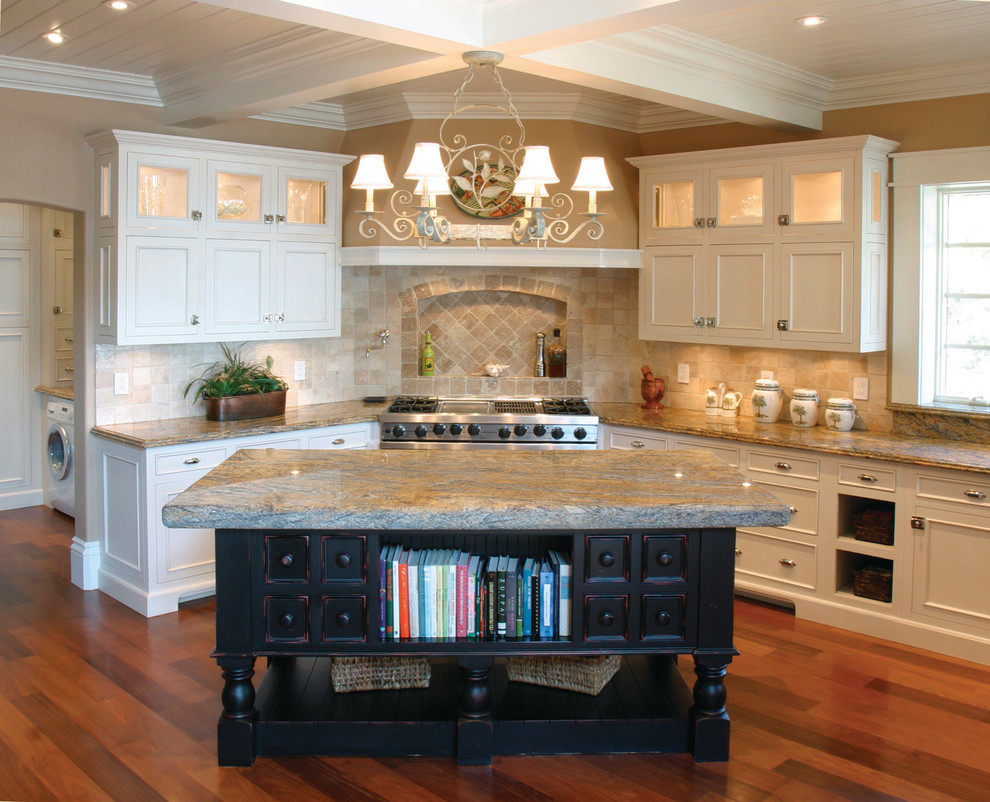 Example of a large arts and crafts l-shaped dark wood floor and brown floor eat-in kitchen design in Bridgeport with white cabinets, beige backsplash, stainless steel appliances, an island, recessed-panel cabinets, granite countertops and terra-cotta backsplash