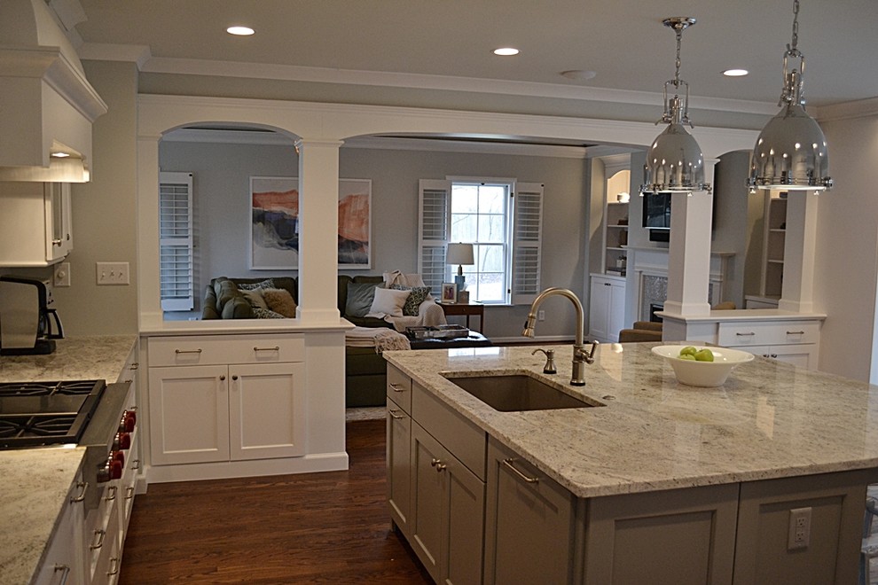 Enclosed kitchen - large traditional l-shaped dark wood floor and brown floor enclosed kitchen idea in St Louis with an undermount sink, shaker cabinets, white cabinets, granite countertops, stainless steel appliances, an island, gray backsplash and glass tile backsplash