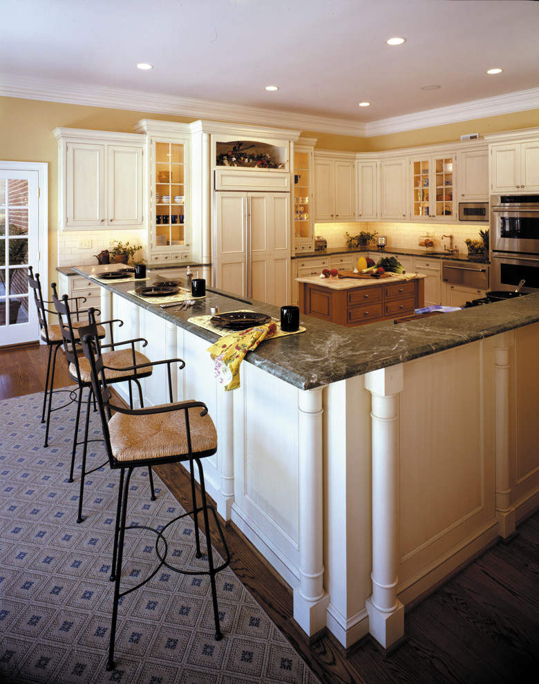 Eat-in kitchen - huge traditional l-shaped dark wood floor eat-in kitchen idea in DC Metro with an undermount sink, beaded inset cabinets, white cabinets, granite countertops, white backsplash, ceramic backsplash, stainless steel appliances and two islands