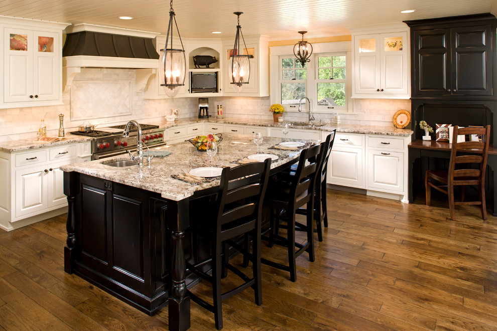 Inspiration for a large timeless l-shaped brown floor and dark wood floor eat-in kitchen remodel in Minneapolis with an undermount sink, white cabinets, white backsplash, an island, stainless steel appliances, granite countertops, raised-panel cabinets, marble backsplash and multicolored countertops