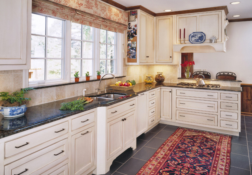 Kitchen/diner in Cincinnati with a double-bowl sink, flat-panel cabinets, white cabinets, marble worktops, yellow splashback, stainless steel appliances, porcelain flooring and an island.