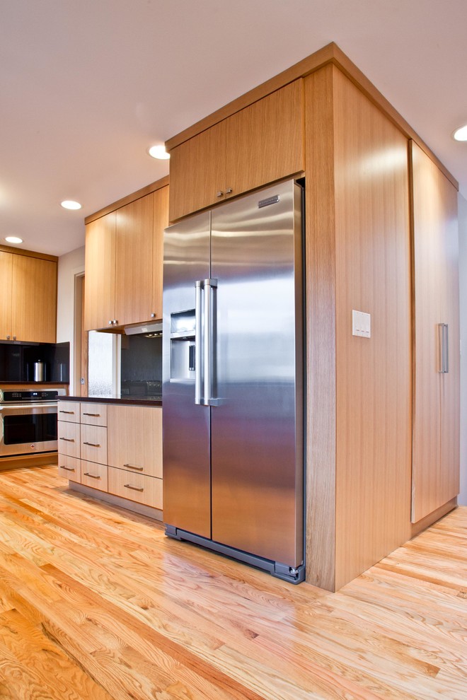 This is an example of a contemporary l-shaped enclosed kitchen in Seattle with a belfast sink and flat-panel cabinets.