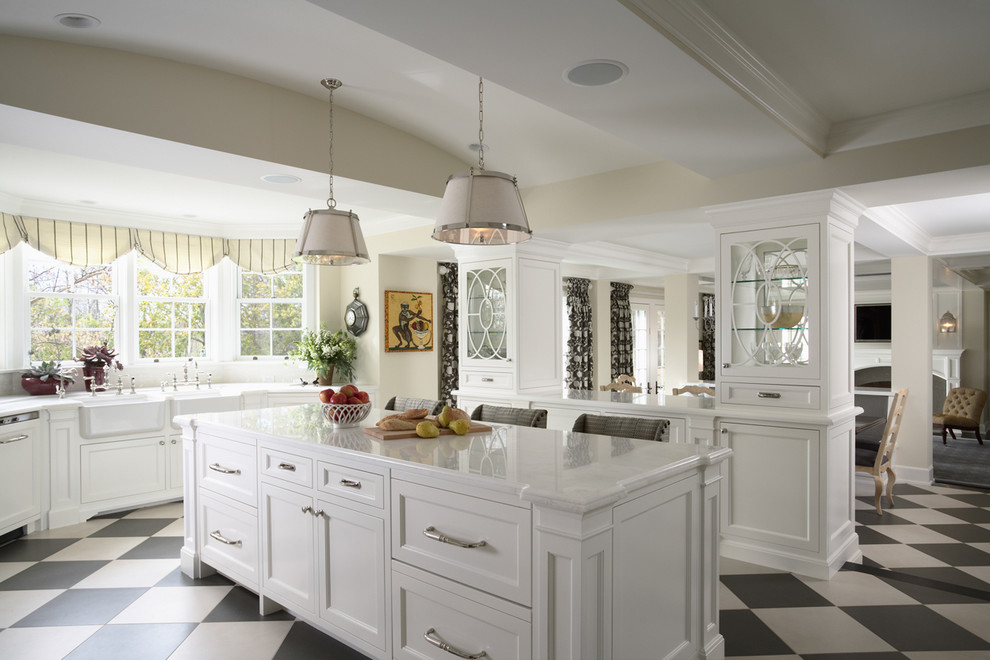Large elegant u-shaped multicolored floor enclosed kitchen photo in Minneapolis with a farmhouse sink, marble countertops, an island, recessed-panel cabinets, white backsplash, stone tile backsplash and stainless steel appliances
