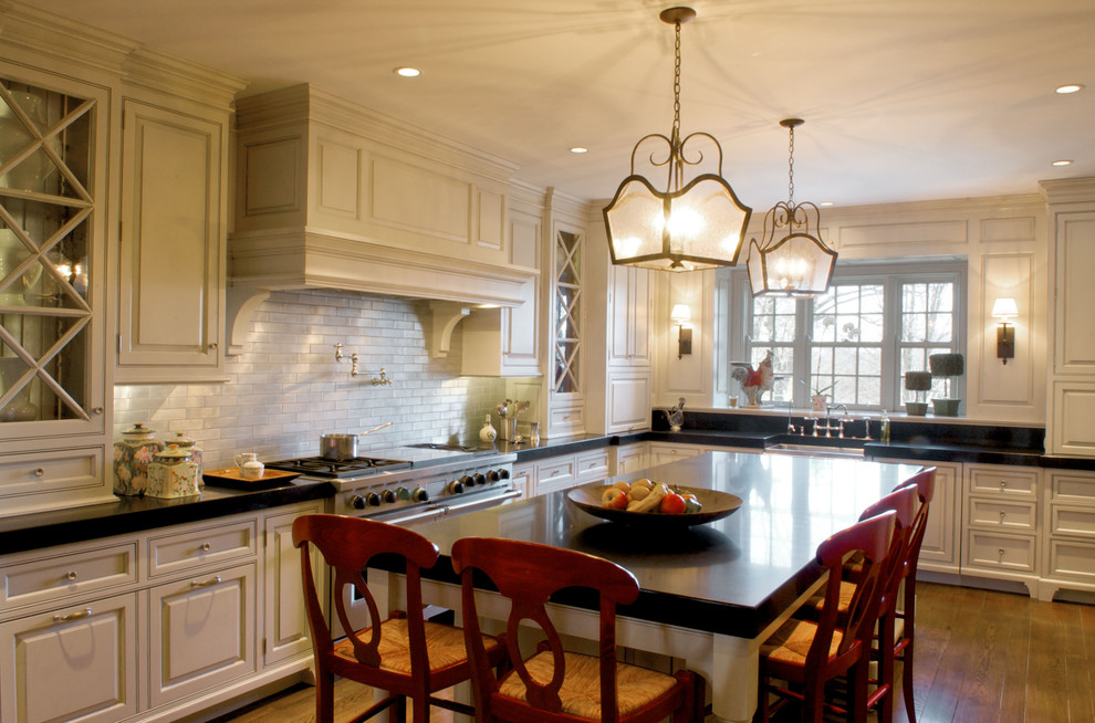 Elegant kitchen photo in Cincinnati with beaded inset cabinets, subway tile backsplash and beige cabinets