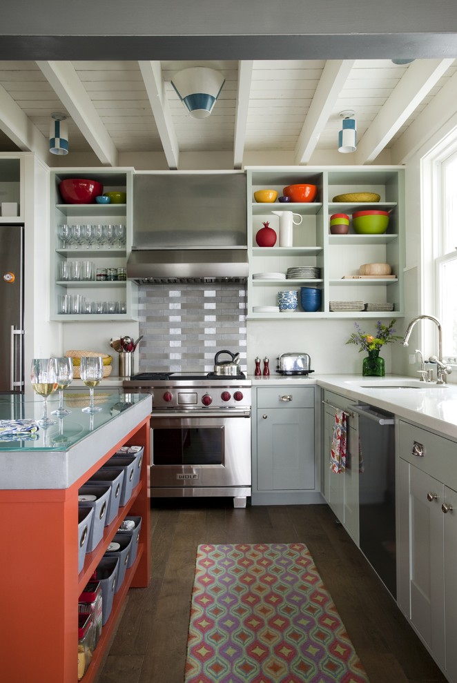 Coastal l-shaped kitchen in Boston with concrete worktops, a submerged sink, open cabinets, grey cabinets, metallic splashback, metal splashback and stainless steel appliances.