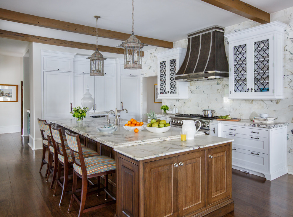 Example of a classic galley medium tone wood floor kitchen design in Jacksonville with shaker cabinets, white cabinets, stainless steel appliances and an island