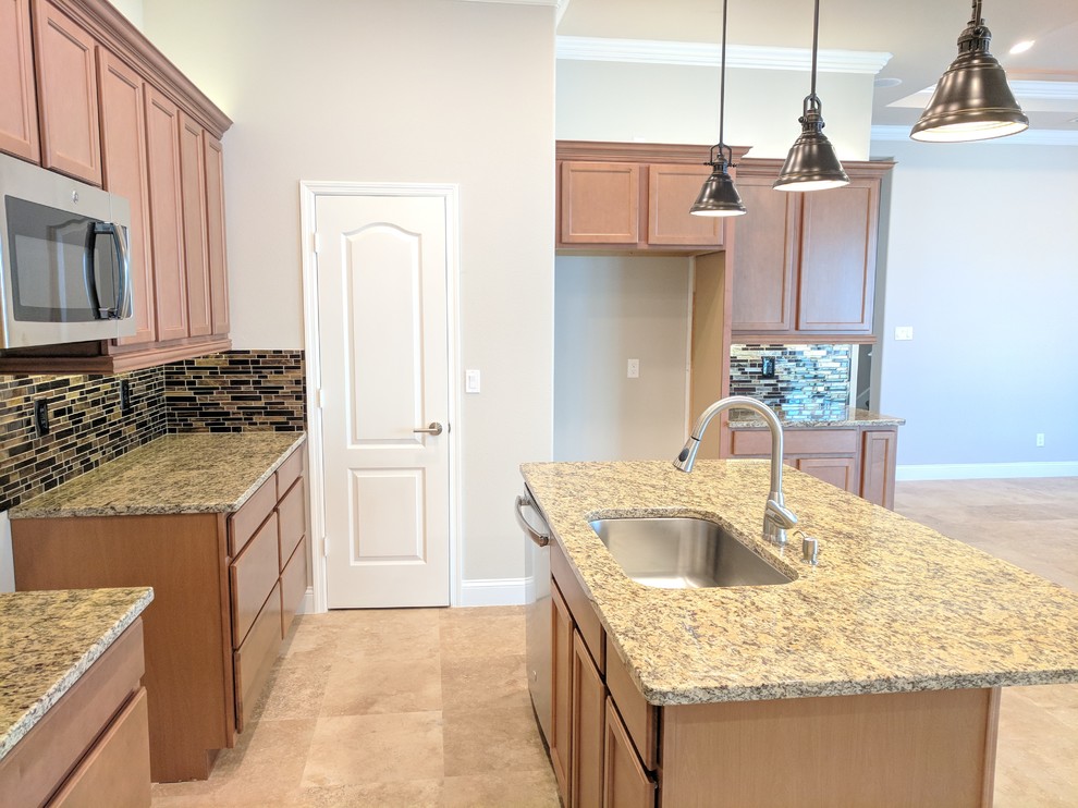 Example of a mid-sized trendy l-shaped marble floor and beige floor open concept kitchen design in Other with an undermount sink, medium tone wood cabinets, granite countertops, multicolored backsplash, mosaic tile backsplash, stainless steel appliances, an island and raised-panel cabinets