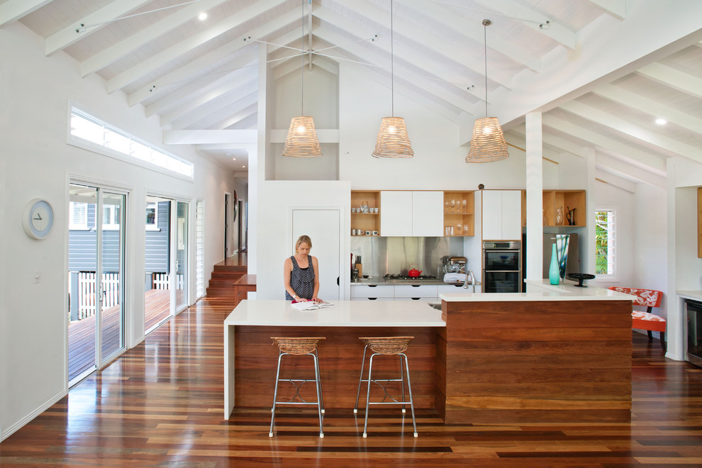 Open concept kitchen - contemporary galley open concept kitchen idea in Brisbane with flat-panel cabinets, white cabinets, metallic backsplash and metal backsplash