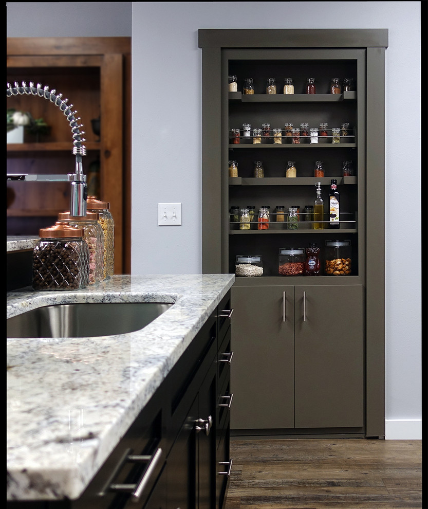 Example of a large trendy linoleum floor and brown floor kitchen pantry design in Salt Lake City with a single-bowl sink, flat-panel cabinets, gray cabinets, granite countertops, black backsplash, stainless steel appliances and gray countertops