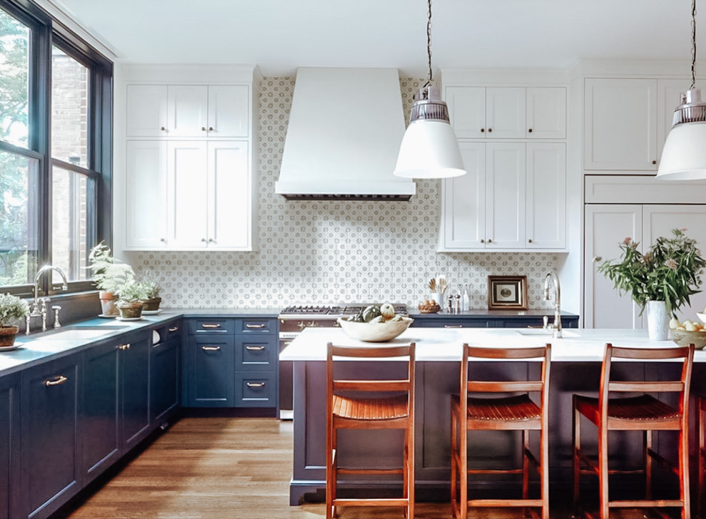 Example of a large l-shaped medium tone wood floor and brown floor eat-in kitchen design in Dallas with multicolored backsplash, ceramic backsplash, an island, white countertops, blue cabinets, quartz countertops, white appliances, an undermount sink and shaker cabinets