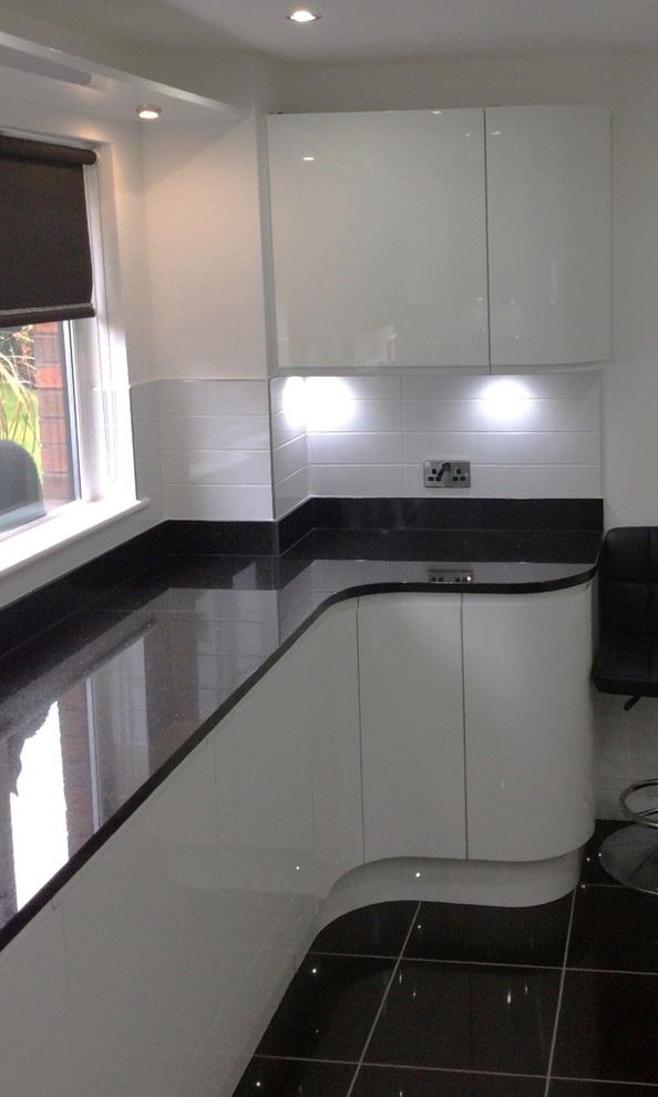 This is an example of a large contemporary l-shaped kitchen in Glasgow with a built-in sink, white cabinets, granite worktops, yellow splashback, stainless steel appliances, ceramic flooring and an island.