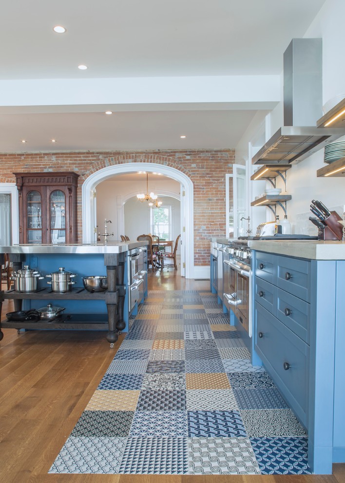 Inspiration for a large traditional single-wall open plan kitchen in Toronto with shaker cabinets, blue cabinets, concrete worktops, white splashback, stainless steel appliances, ceramic flooring, an island, a belfast sink, porcelain splashback and multi-coloured floors.